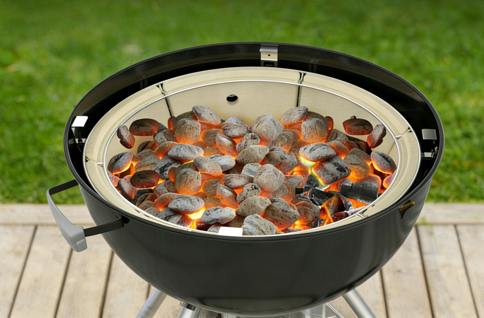Charcoal grill with glowing embers on a wooden deck
